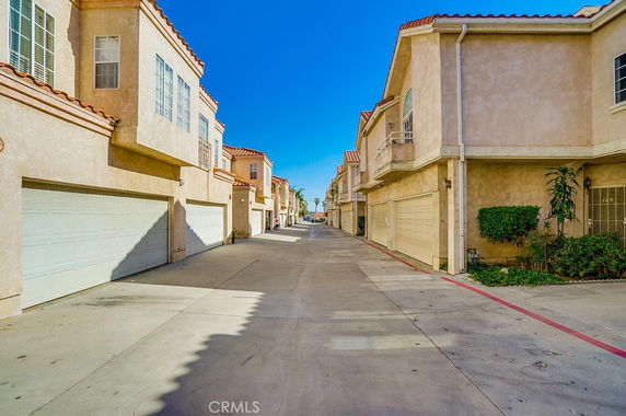 View of a street lined with two-story houses featuring garages.