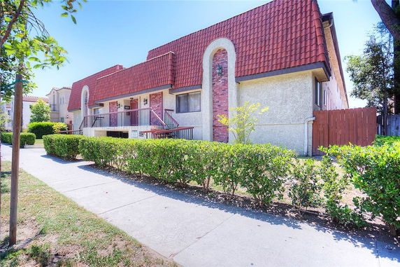 Front view of a building with a red-tiled roof and multiple entrances.
