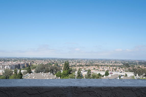 Panoramic view of a cityscape with buildings and trees.