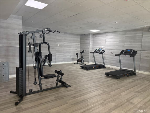 Indoor gym area with exercise equipment including treadmills and a weight machine.