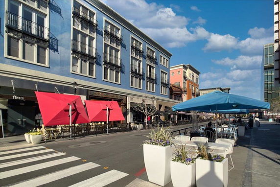 Front view of a multi-story building with outdoor seating area.