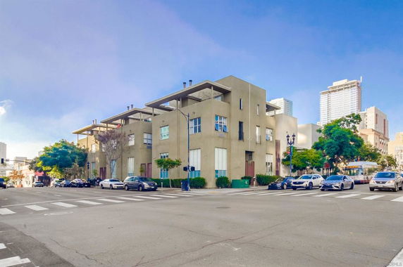 Street view of a multi-story apartment building with a modern design.