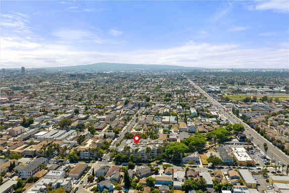 Panoramic aerial view of a city with numerous buildings and streets extending into the distance.