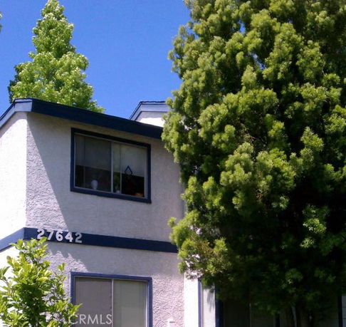 Front view of a two-story house with windows and visible house number.
