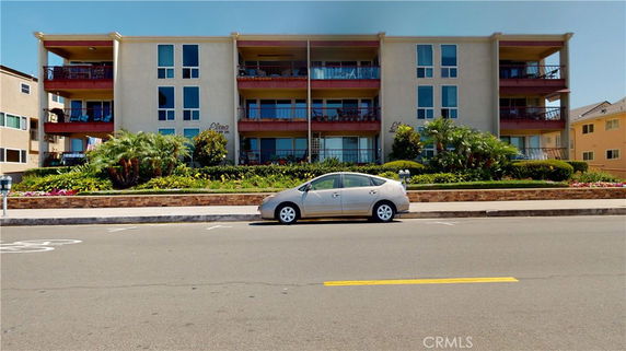 Front view of a multi-story residential building with balconies.
