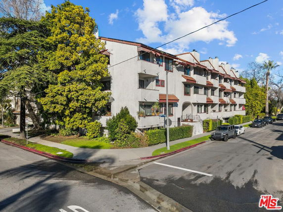 Front view of a multi-story residential building with balconies.
