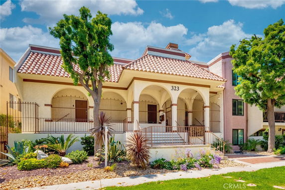 Front view of a house with a tiled roof and arched entrance.