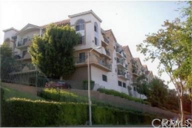 Front view of a multi-story residential building with balconies.