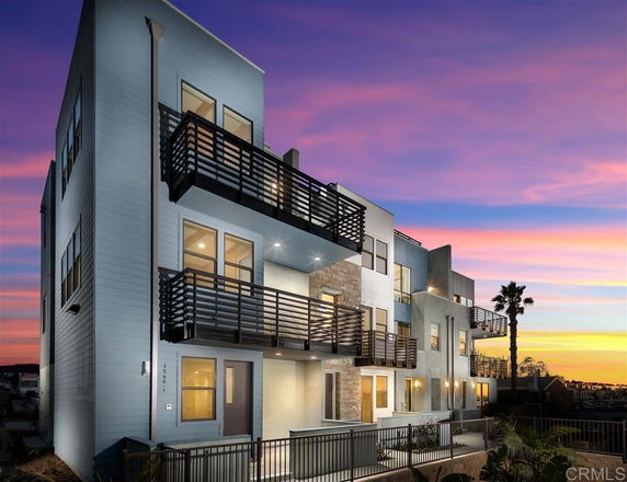 Front view of a modern multi-story building with balconies.