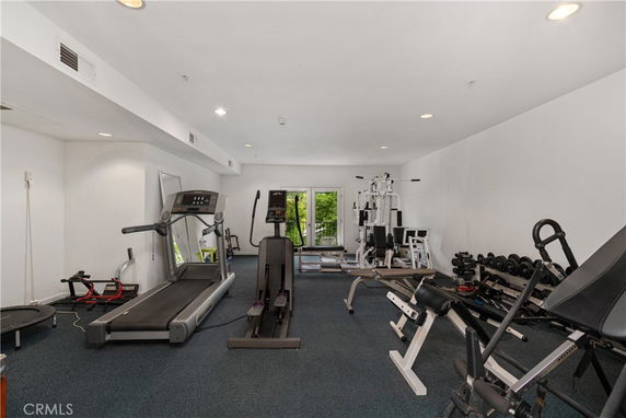 Indoor gym area with various exercise equipment.