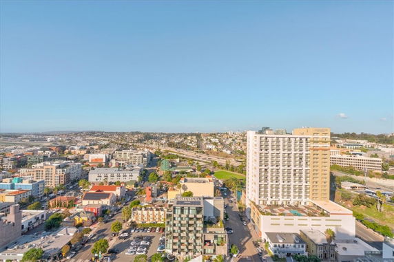 Panoramic view of a cityscape featuring multiple buildings and a distant horizon.