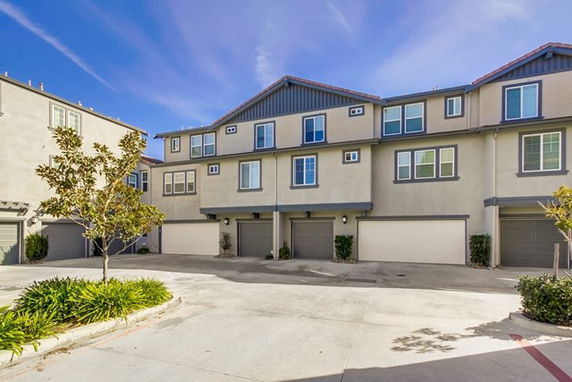 Front view of a townhouse complex with multiple garages.