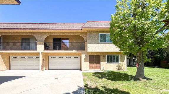 Front view of a two-story house with attached double garages.