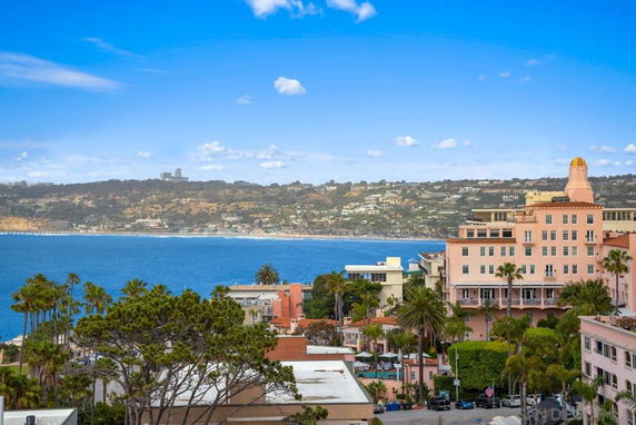 View overlooking a coastal landscape with several buildings and the ocean.