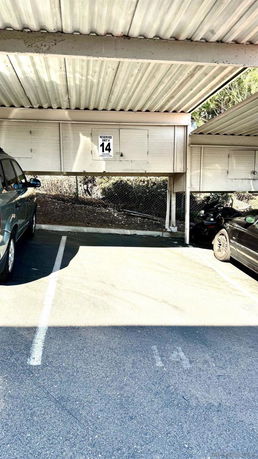 Covered parking space with reserved parking signage.