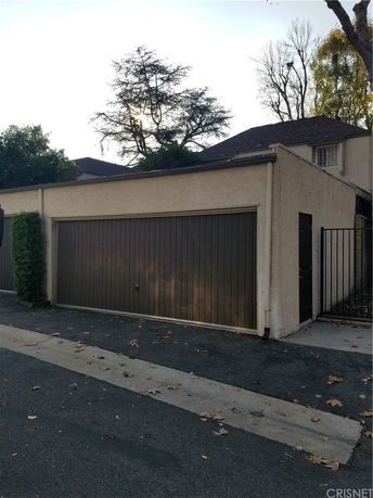 Front view of a single-story building with a garage door.