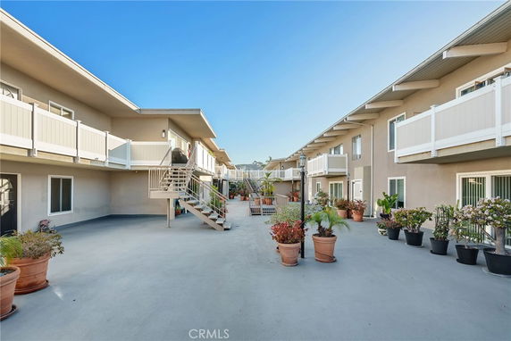 View of residential building with two levels and balconies.