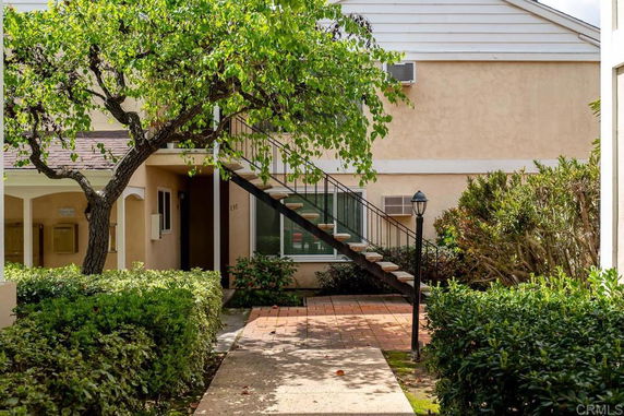 Front view of a residential building with external staircase.