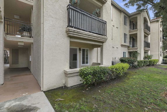 Front view of a multi-story apartment building with balconies.