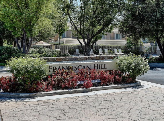 Front view of a residential building with a sign reading 'Franciscan Hill'.