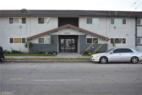 Front view of a two-story building with a central entrance and multiple windows.