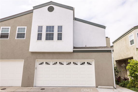 Front view of a two-story house with a garage.