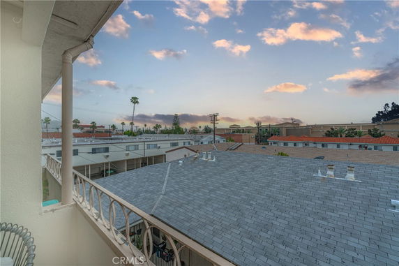 Panoramic view over rooftops and surrounding area from a building.