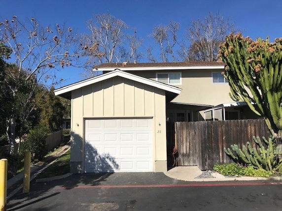 Front view of a two-story house with an attached single garage.