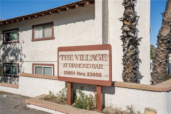 Front view of a building with a sign for The Village at Diamond Bar.