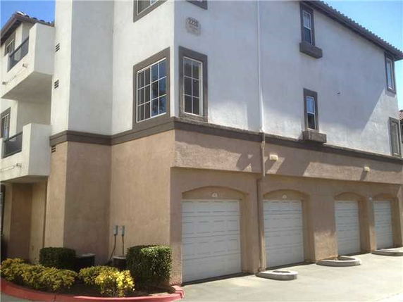 Front view of a multi-story building with multiple garage doors.
