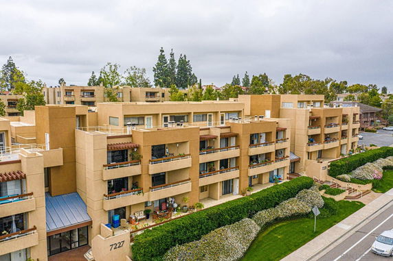 Front view of a multi-story apartment building with balconies.