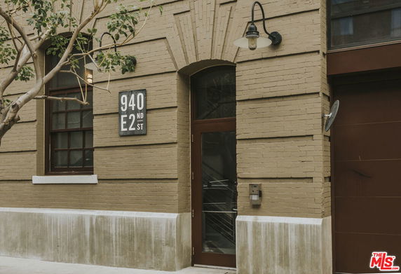 Front view of a building entrance with numbered signage and a window.