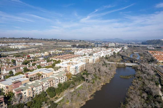 Aerial view of a residential area with multiple buildings near a river.