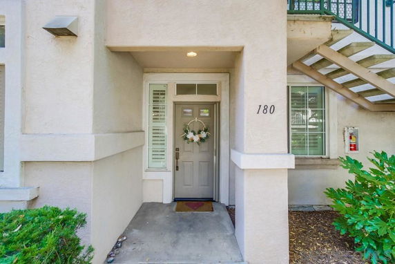 Front view of a house entrance with stairs on the right.
