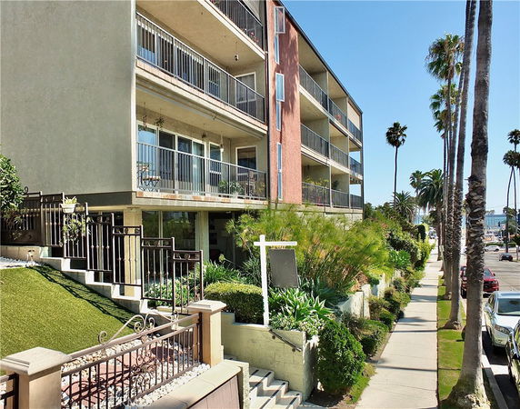 Front view of a multi-story apartment building with balconies.