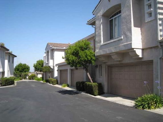 Front view of a row of two-story houses with garages.