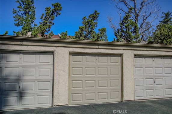 Row of closed garage doors in an outdoor parking area