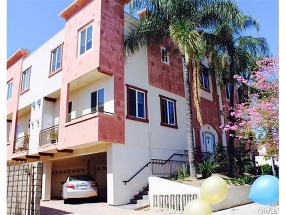 Front view of a multi-story house with an attached garage.