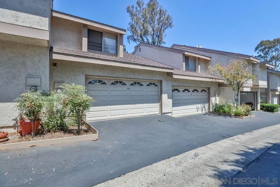 Front view of a townhouse with double garages.