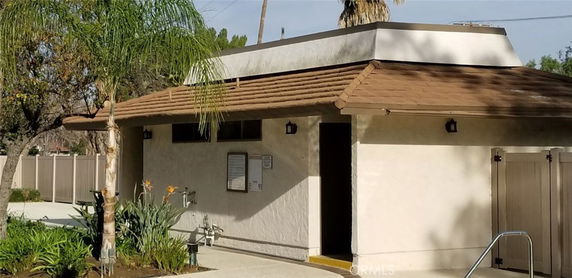 Front view of a small single-story building with a sloped roof.