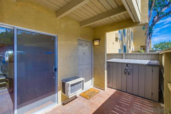 Front view of a house with patio area and sliding glass door.
