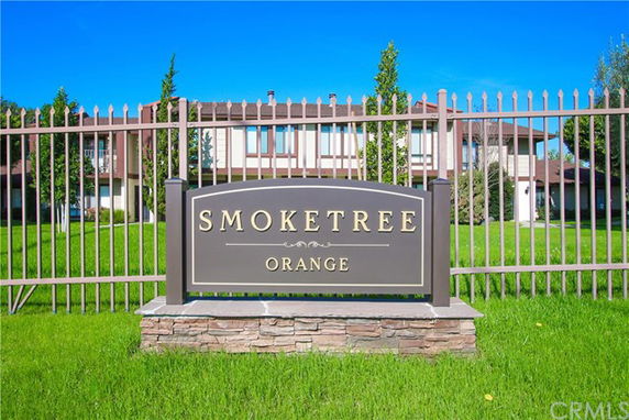 Front view of a two-story building behind a gated fence.