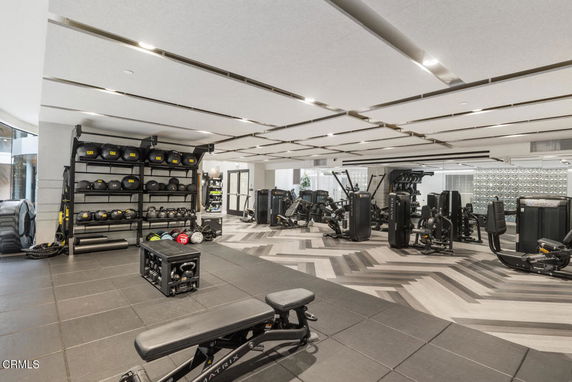 Interior of a gym with various exercise equipment and weights.