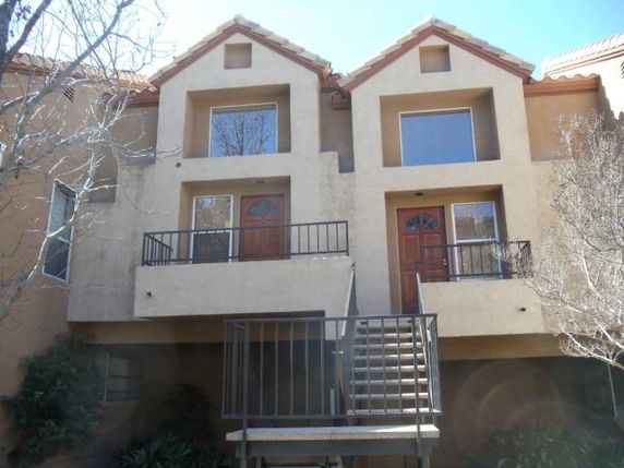 Front view of a two-story townhouse with two entries and small balconies.