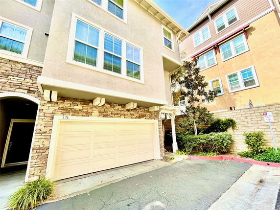 Front view of a multi-story house with a double garage.