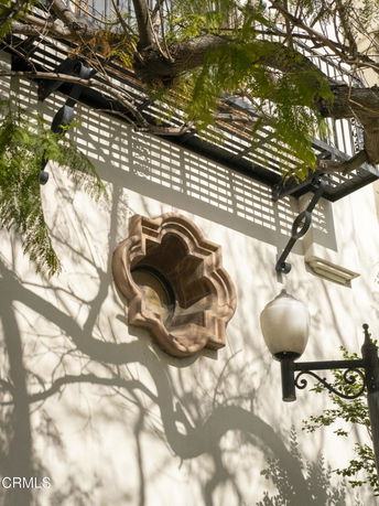 Front view of a building with a decorative window and lamp post.