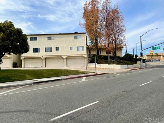 Front view of a two-story building with multiple garages on the lower level.