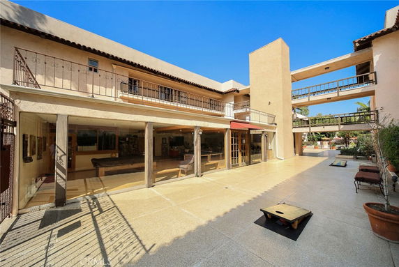 Front view of a multi-story building with open patios and balconies.