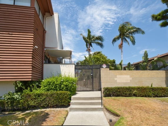 Front view of a multi-story building with a gated entrance.