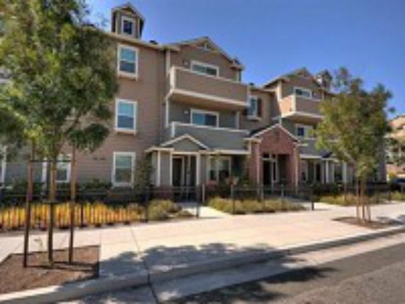 Front view of a multi-story residential building with balconies.